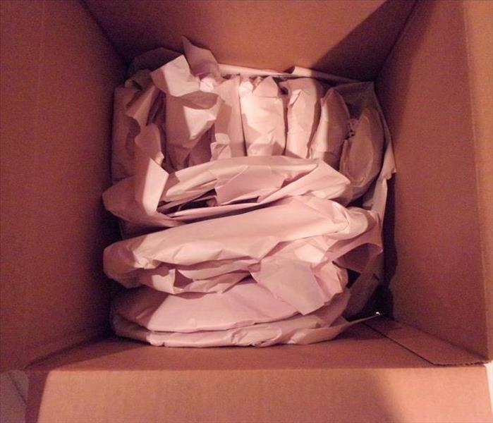 A box of nicely packed belongings after a loss