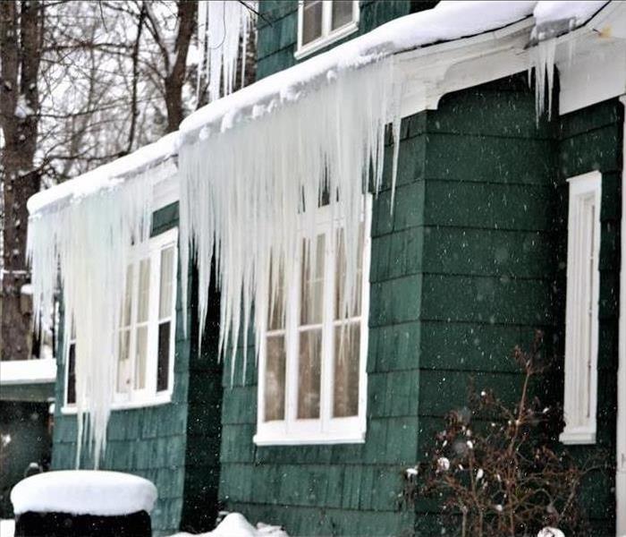 Snow and ice cause ice dams on a home's roof